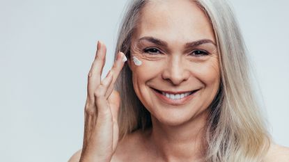 woman applying moisturiser