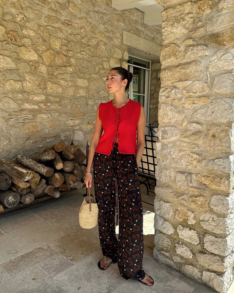 Summer Outfit Ideas 2025: @smythsisters wears a pair of printed trousers and a tie-front top