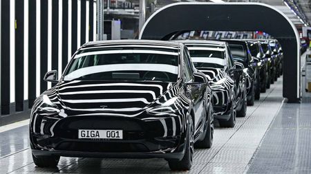 A line of black Tesla Model Y electric vehicles on production line at Gigafactory