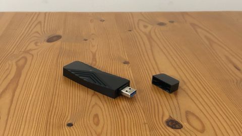 D-Link AX1800 Wi-Fi 6 USB Adaptor on a wooden table