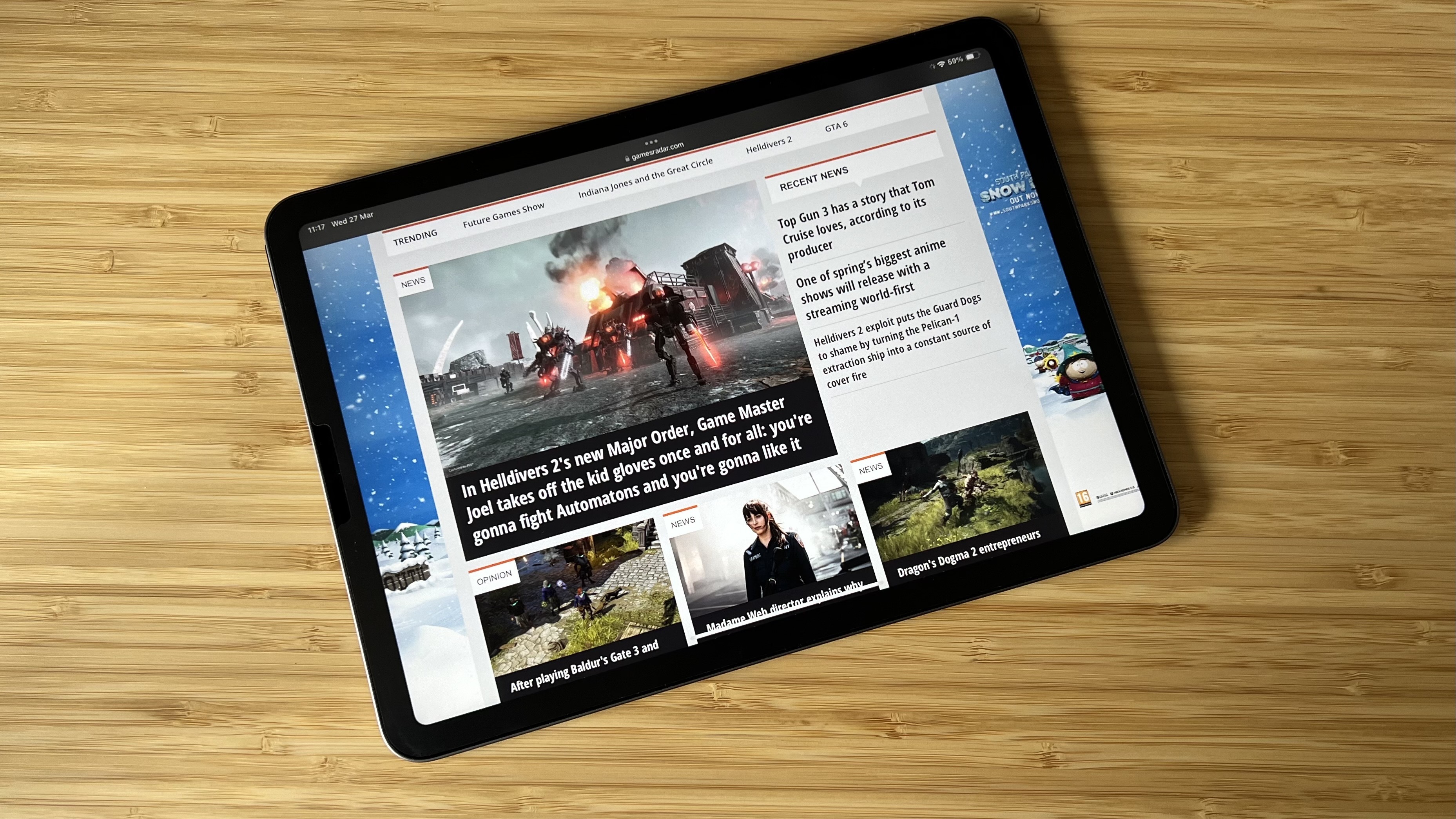 iPad Air showing GamesRadar webpage on a wooden table