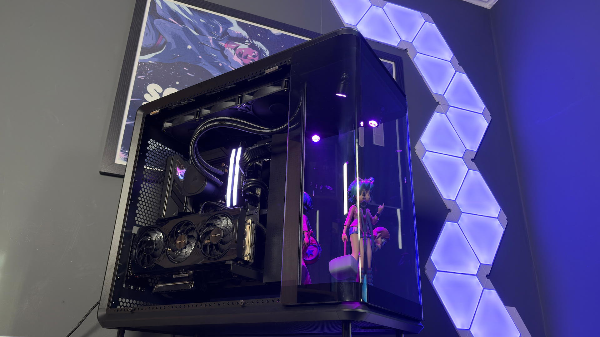 The CoolerMaster MasterFrame 360 Panoramic PC case with various components installed on a desk.