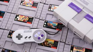 SNES laid on top of a collection of games