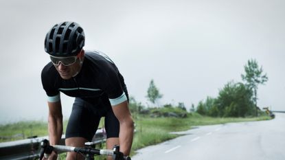 Image shows a rider wearing one of the best budget bike helmets for cycling