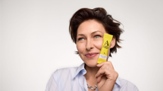 Emma Willis next to a yellow tubed product