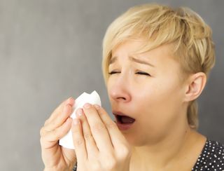 woman sneezing