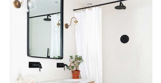 white bathroom with a black shower rail with a clean white shower curtain