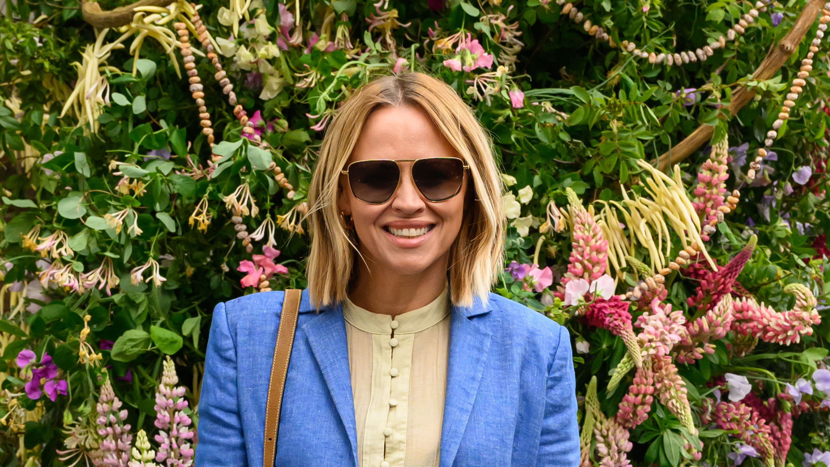 Kimberley Walsh wearing sunglasses and a blue blazer