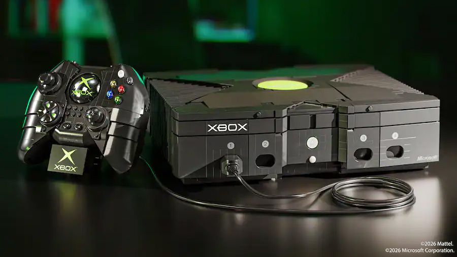 Mattel Brick Shop original Xbox console with green logo and wired Duke controller on a dark reflective surface, lit with green highlights.