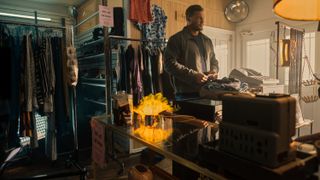 Reacher (Alan Ritchson) in a thrift store in Reacher season 2 episode 1