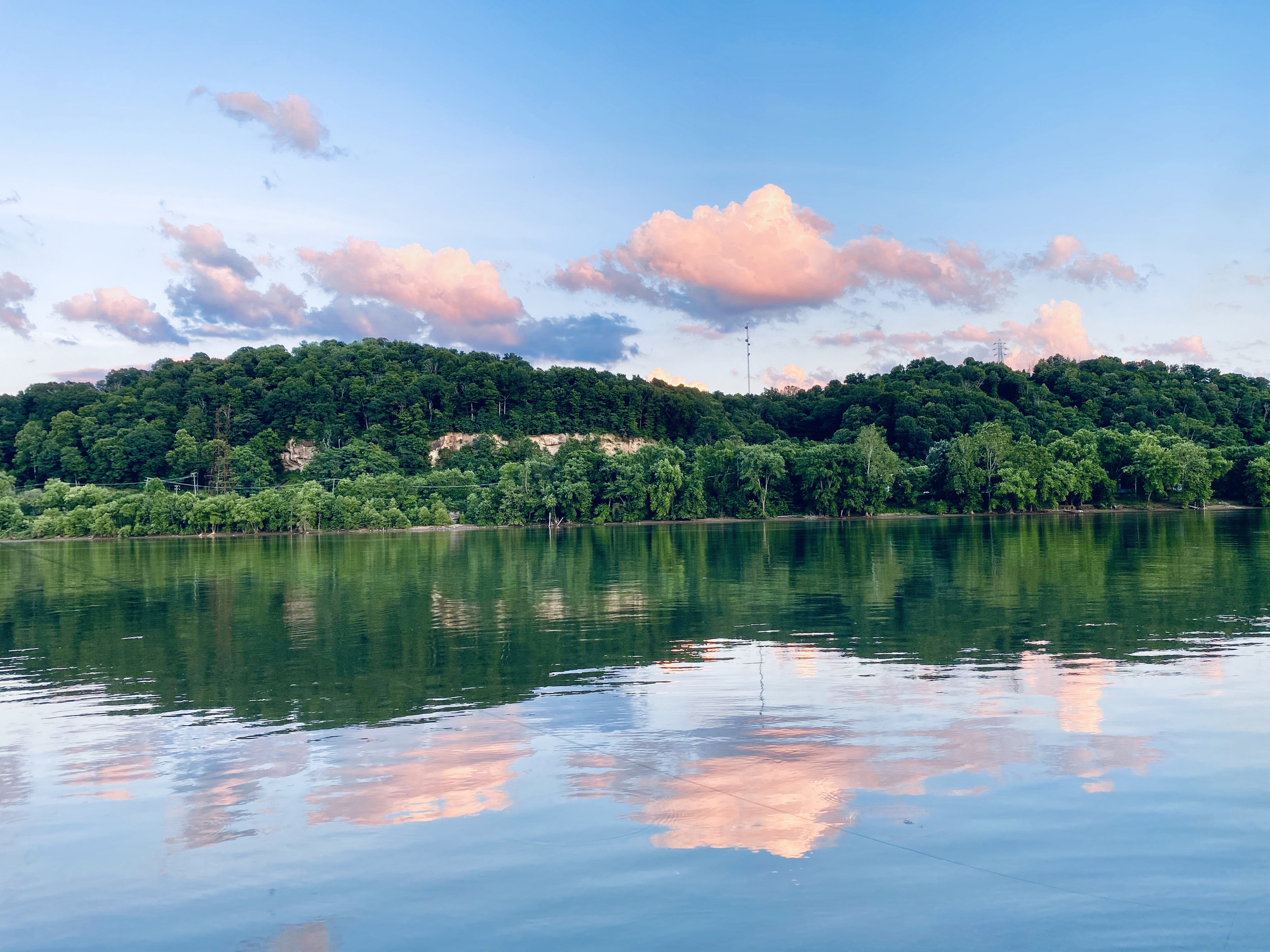 scenic view of a tree-lined lake at sunset in Meigs County, Ohio