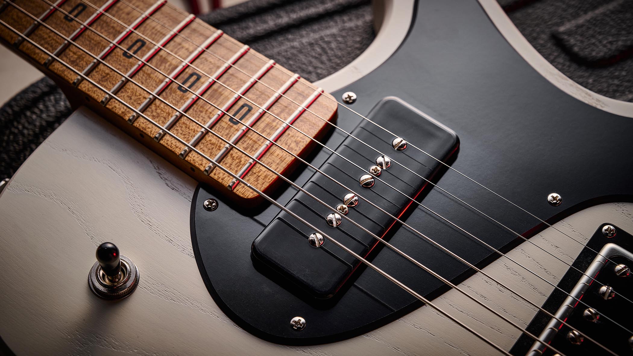 PJD Carey Classic: the translucent white singlecut has a handsome roasted figured maple neck, a black pickguard, and a P-90/Humbucker pairing.