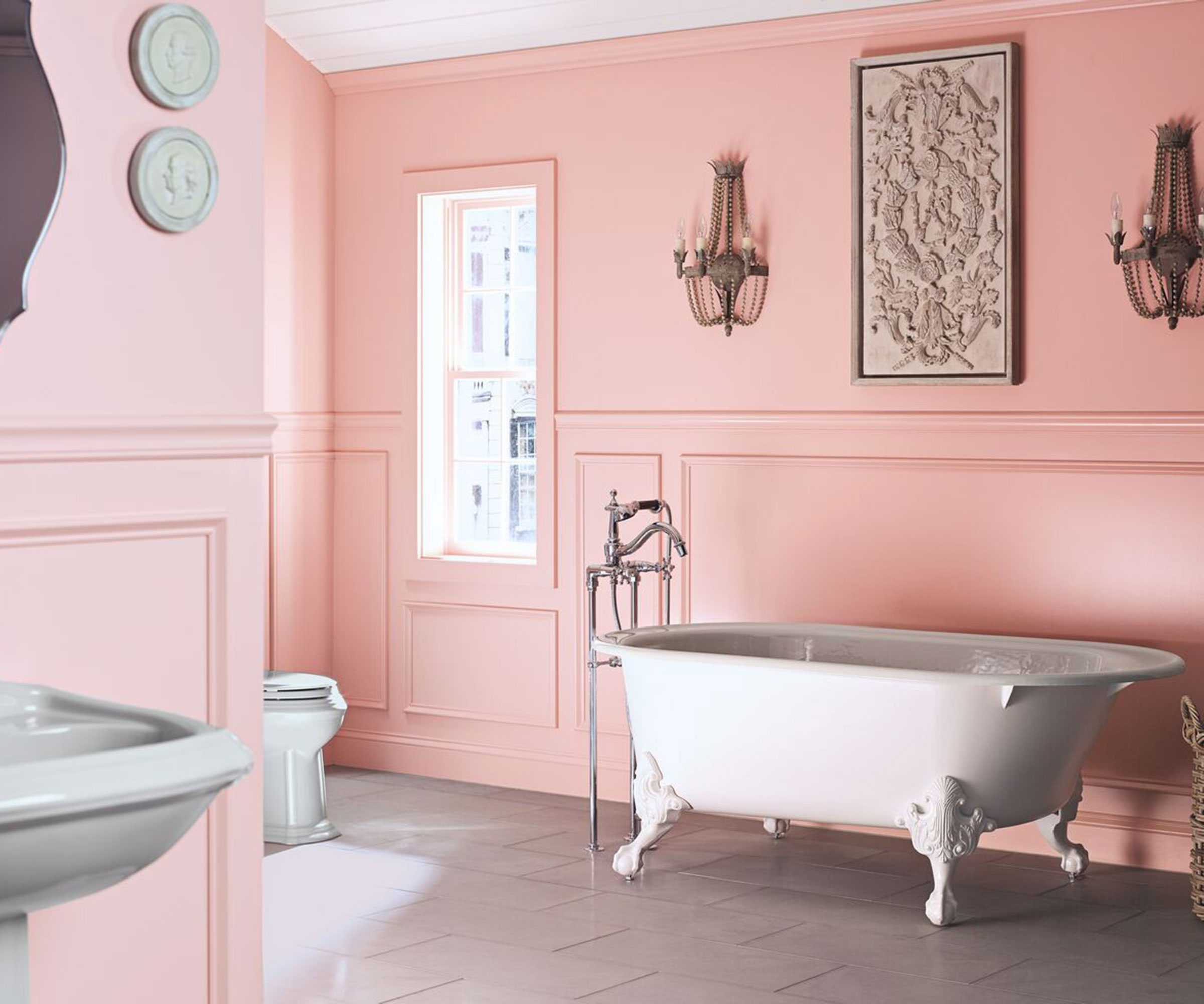 traditional pink bathroom with rolltop bath