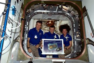 The three-astronaut crew of the International Space Station's Expedition 27 mission pack three origami cranes on the Japanese cargo ship Kounotori 2 (HTV-2) before releasing the spacecraft on Monday, March 28, 2011 to end its mission by burning up in Eart