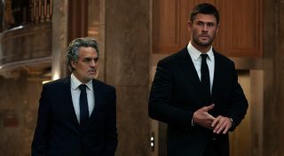 From left to right: Mark Ruffalo and Chris Hemsworth walking together. 