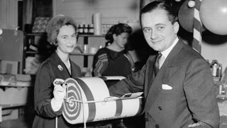 Lord Rupert Nevill (1923 - 1982) and Lady Anne Nevill run the tombola at the YMCA Fair in Londonderry House, Park Lane, London, 21st November 1956.