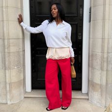 Influencer wearing a polo sweater and red pants