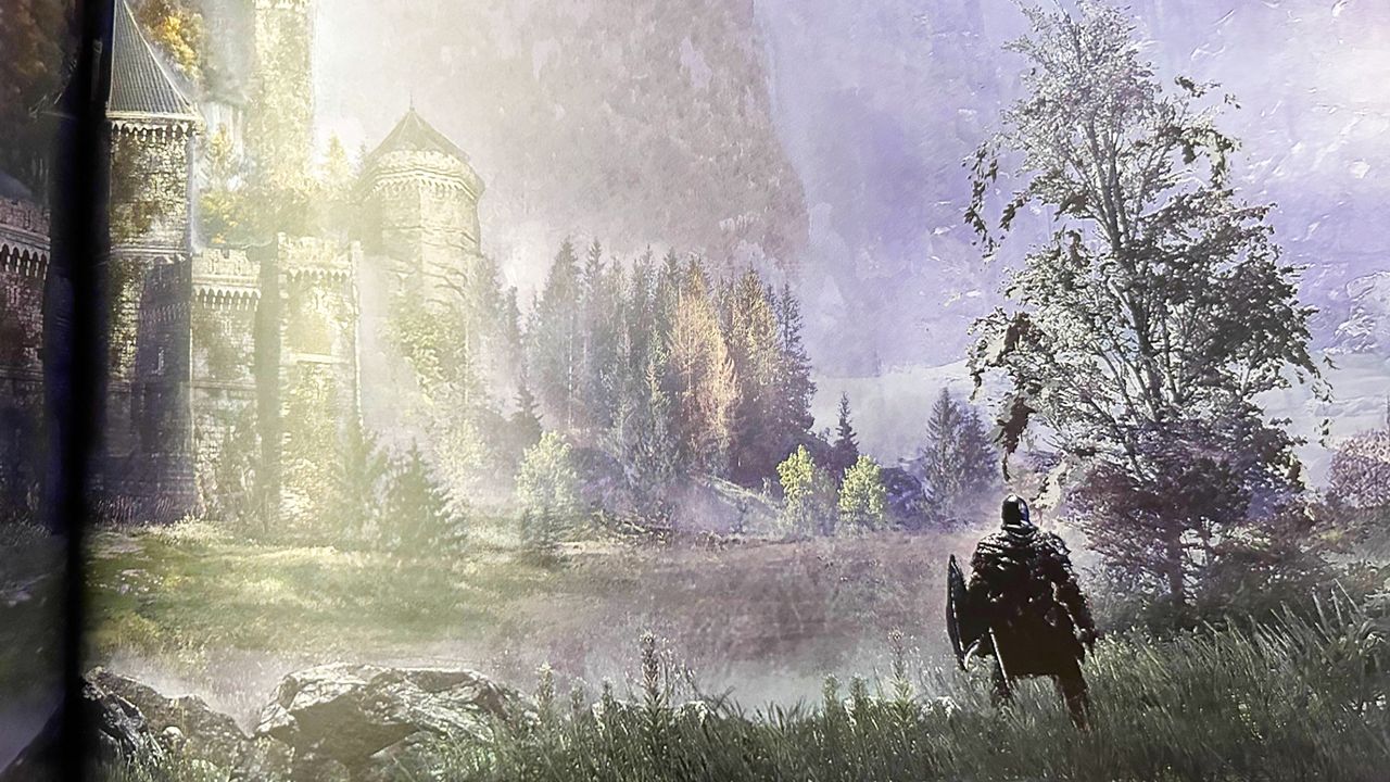 A photo of an Elden Ring concept art book. A player character stand-in steps out toward a lake in a grassy area.