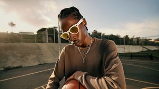 Official lifestyle shots of a person wearing Oakley Meta HSTN smart glasses