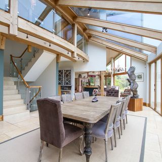 dining area with stair case and glass roof