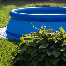 Large blue paddling pool on a lawn