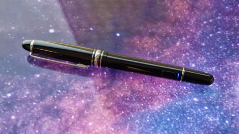 A photo of the Adonit Star stylus on a screen that has a galaxy background
