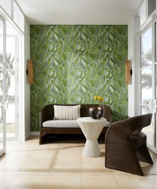 Transitional space with small sofa and side table and green wallpaper