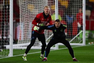 Aaron Ramsdale warms up with Arsenal's Spanish goalkeeping coach Inaki Cana Pavon during the English Premier League football match between Brentford and Arsenal at the Gtech Community Stadium in London on November 25, 2023