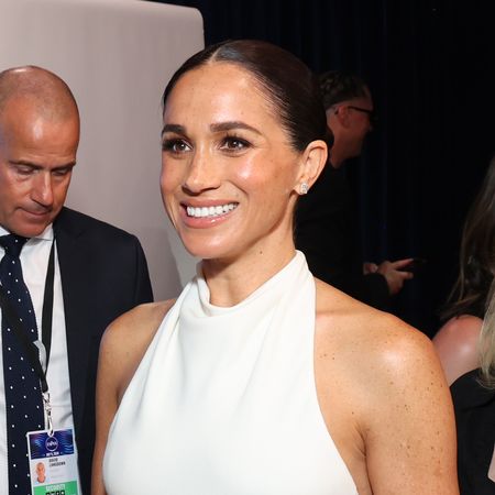 Meghan Markle wears a white halter dress and Taylor Swift wears a white D&ocirc;en top