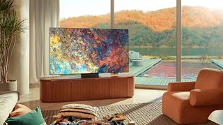 Colorful Samsung screen on wooden media cabinet, pool in background