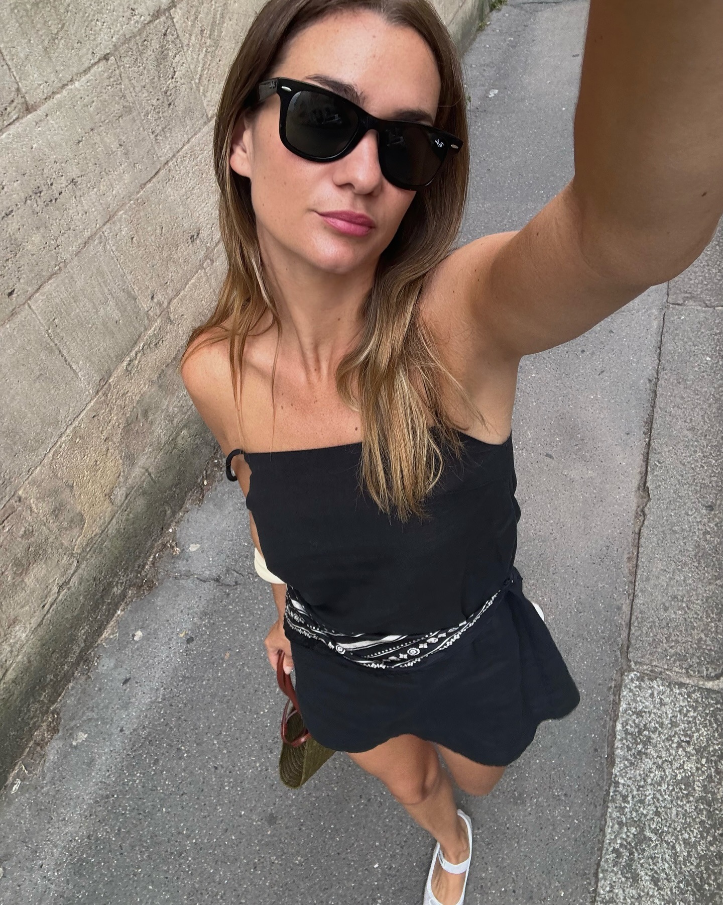 Influencer wearing a flared mini dress and flat shoes
