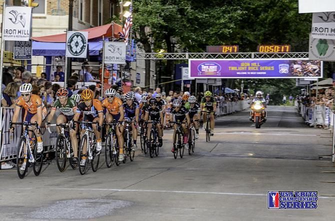 The pro women race along the tree-lined finish straight on Saturday at the USA CRITS Iron Hill Twilight Criterium held in West hester, Pennsylvania