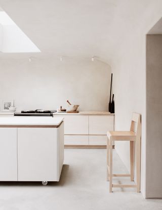 An all white kitchen with wooden elements