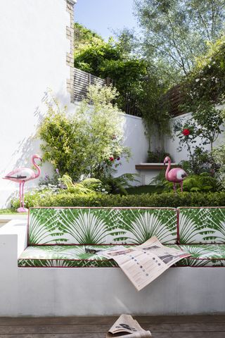 A backyard with seating furnished in green and white