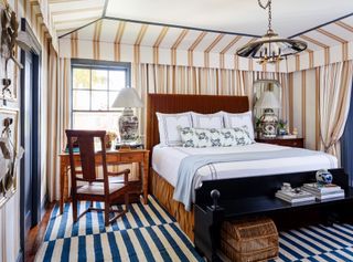fabric draped master bedroom with stripes