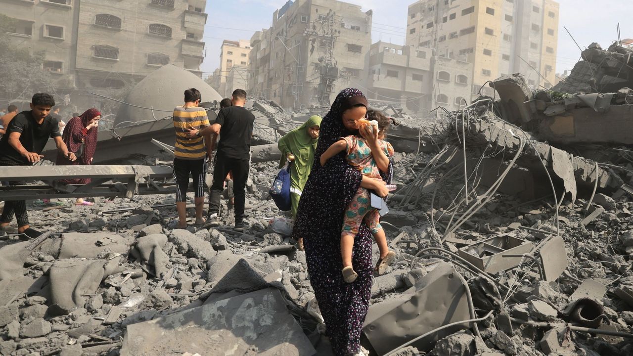 Palestinians evacuate the area following an Israeli airstrike on the Sousi mosque in Gaza City on October 9, 2023. Israel continued to battle Hamas fighters on October 9 and massed tens of thousands of troops and heavy armour around the Gaza Strip after vowing a massive blow over the Palestinian militants&#039; surprise attack.