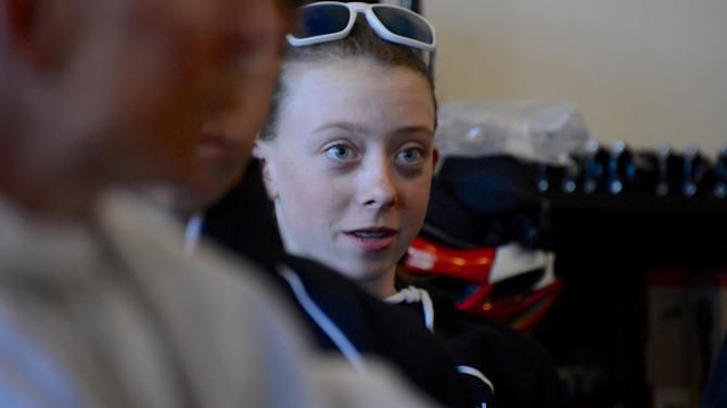 A rider listens during the team camp