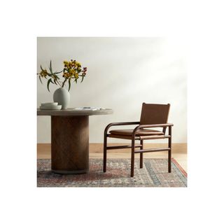 wood and leather dining chair next to round wood table