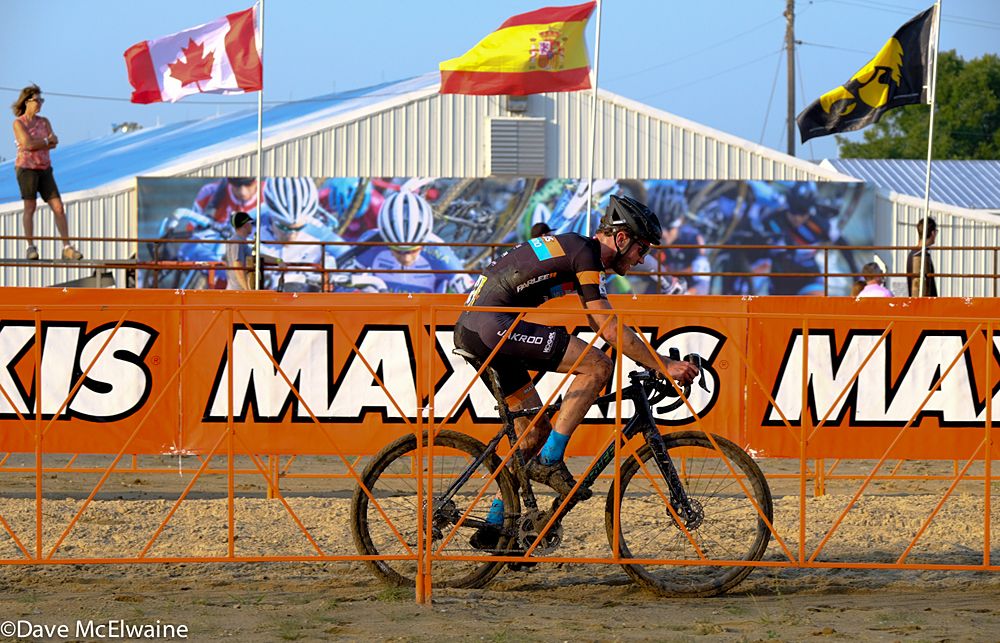 Travis Livermon (USA) riding past a colorful backdrop on the Jingle Cross course
