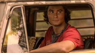 Chase Stokes as John B. looking out a van's window on Outer Banks