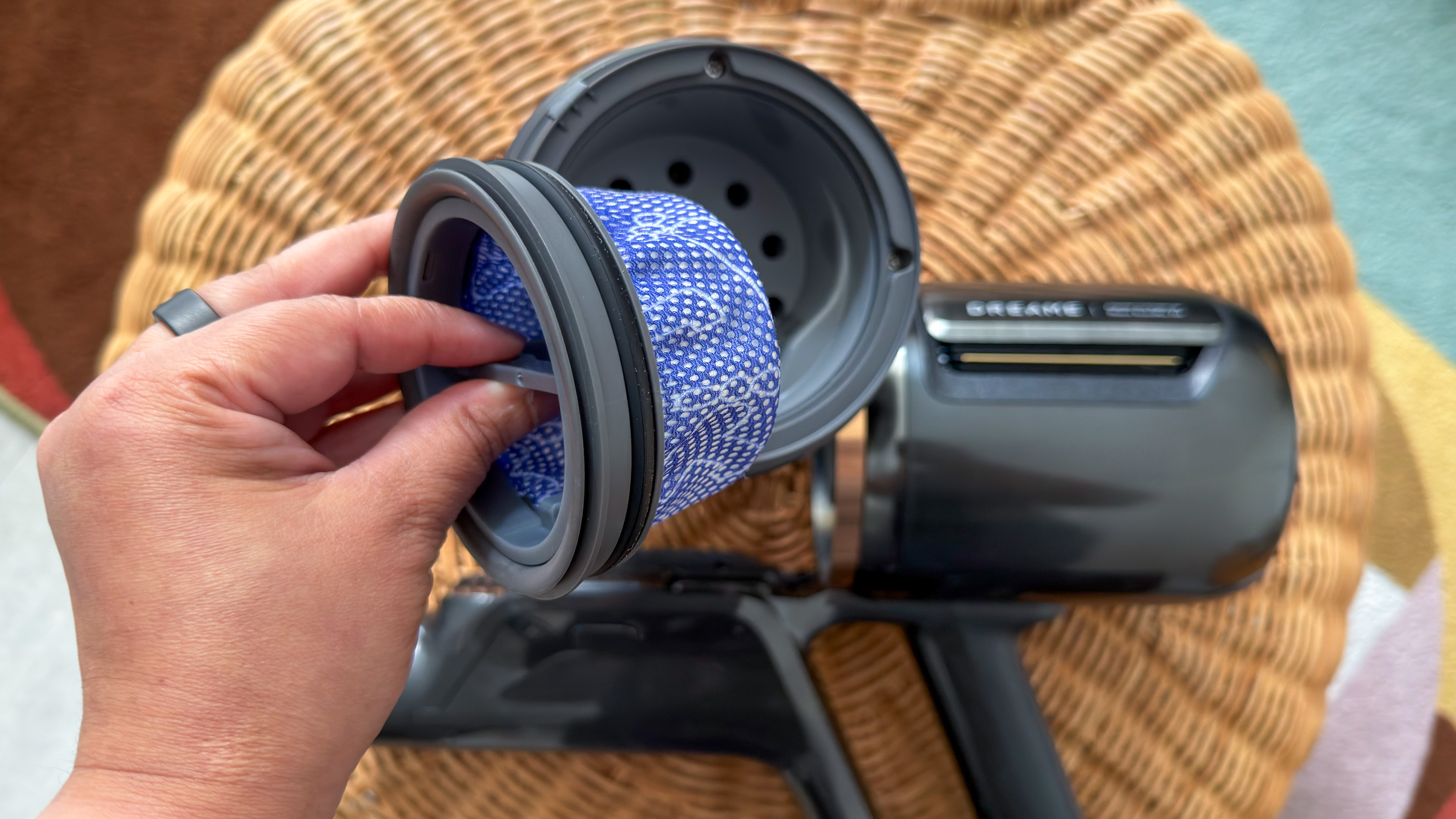 A person removing the filter inside Dreame Z50 Station