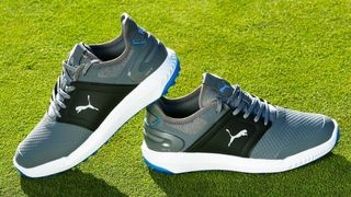 The stunning Puma Ignite Elevate Golf Shoe resting on the golf course showing off its thick sole