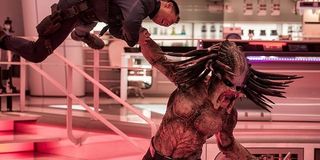 The Predator getting ready to body slam a man