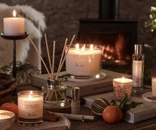 The White Company Christmas candles on a coffee table.