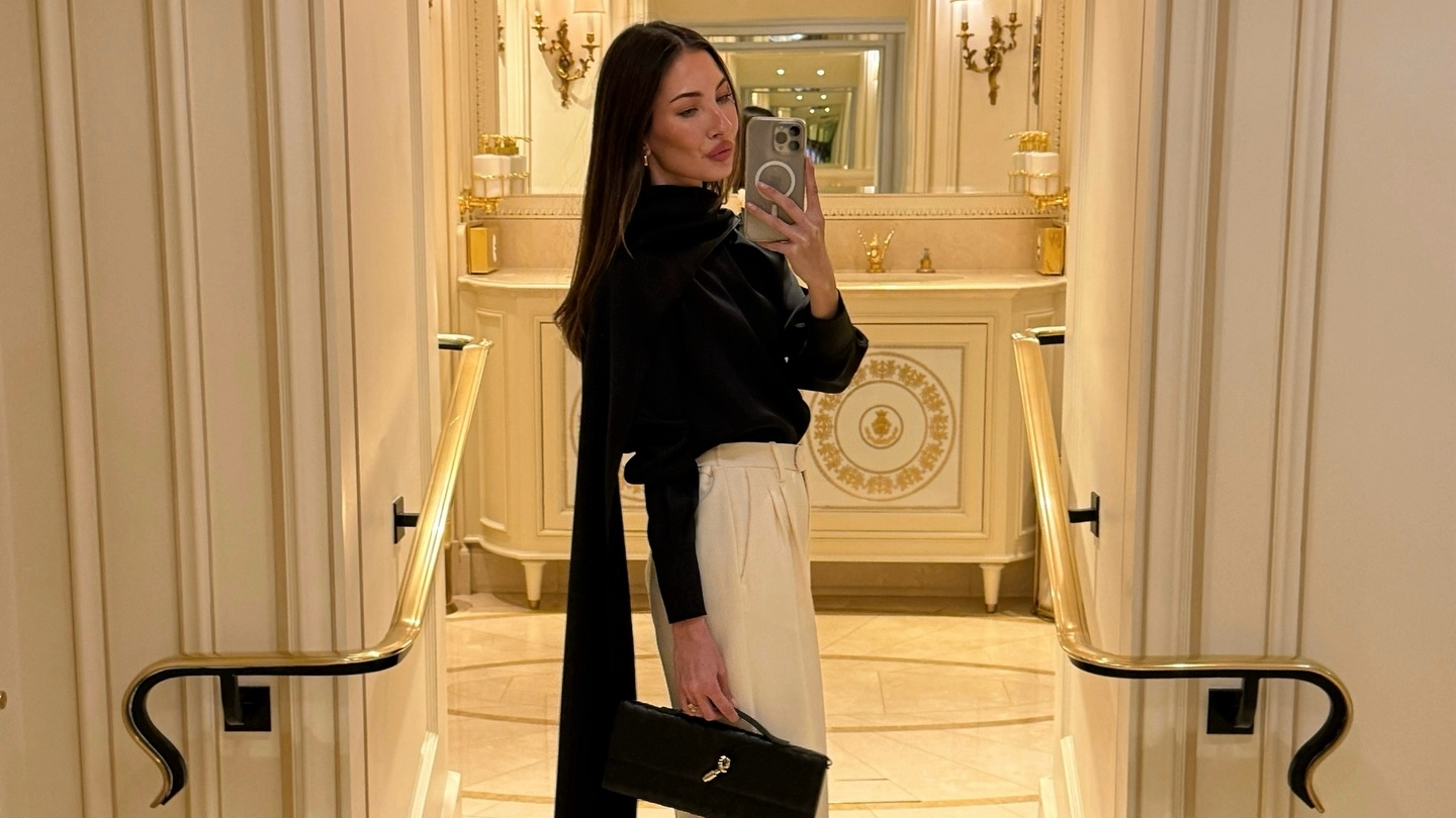 Felicia Akerstrom in a black silk top and cream trousers