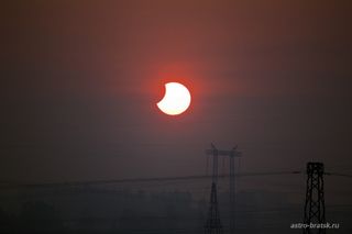 Photographer and skywatcher Svetlana Kulkova snapped this view of the partial solar eclipse of June 1-2, 2011 just after sunrise on June 2 from Bratsk, Russia. The partial solar eclipse was dubbed a "midnight" eclipse as its viewing path crossed the Inter