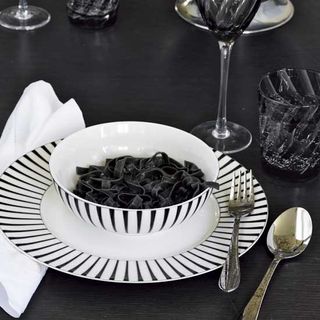 dinnerware with spoons and bowl on plate