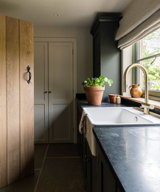 narrow utility room with Belfast sink and granite worktops