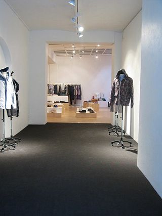 An area with five mannequins wearing jackets and clothes on display in the subsequent section of the building.