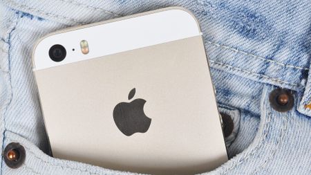 An iPhone 5S in a person's front jeans pocket